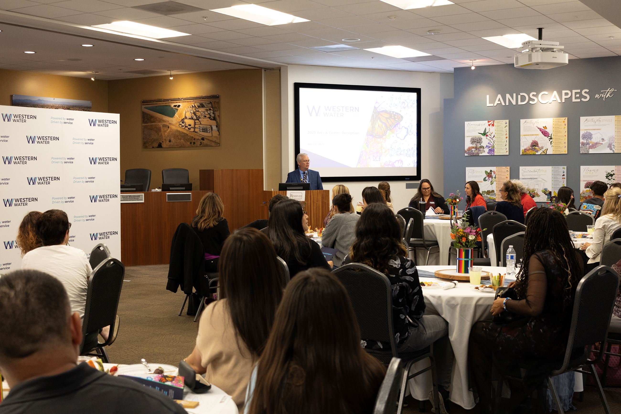 Multiple guests sitting watching the speaker at the Arts & Grants Reception 